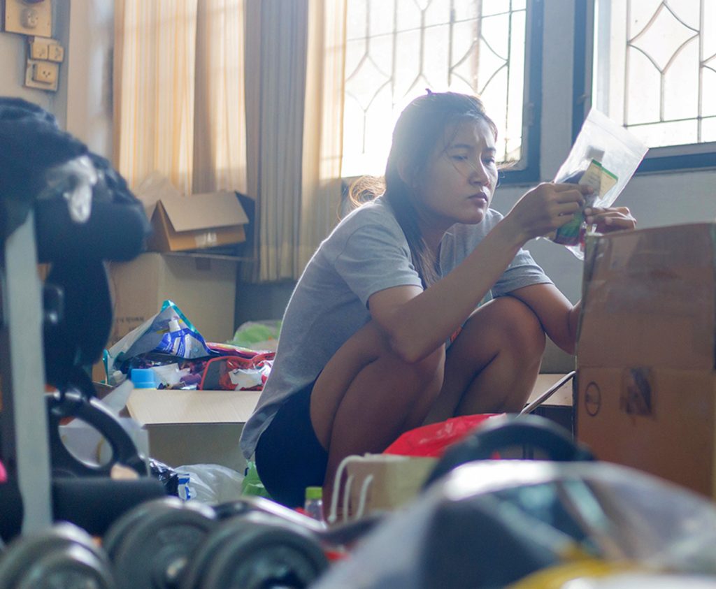 A woman sitting in a room in need of hoarding cleanup services in Santa Ana, CA