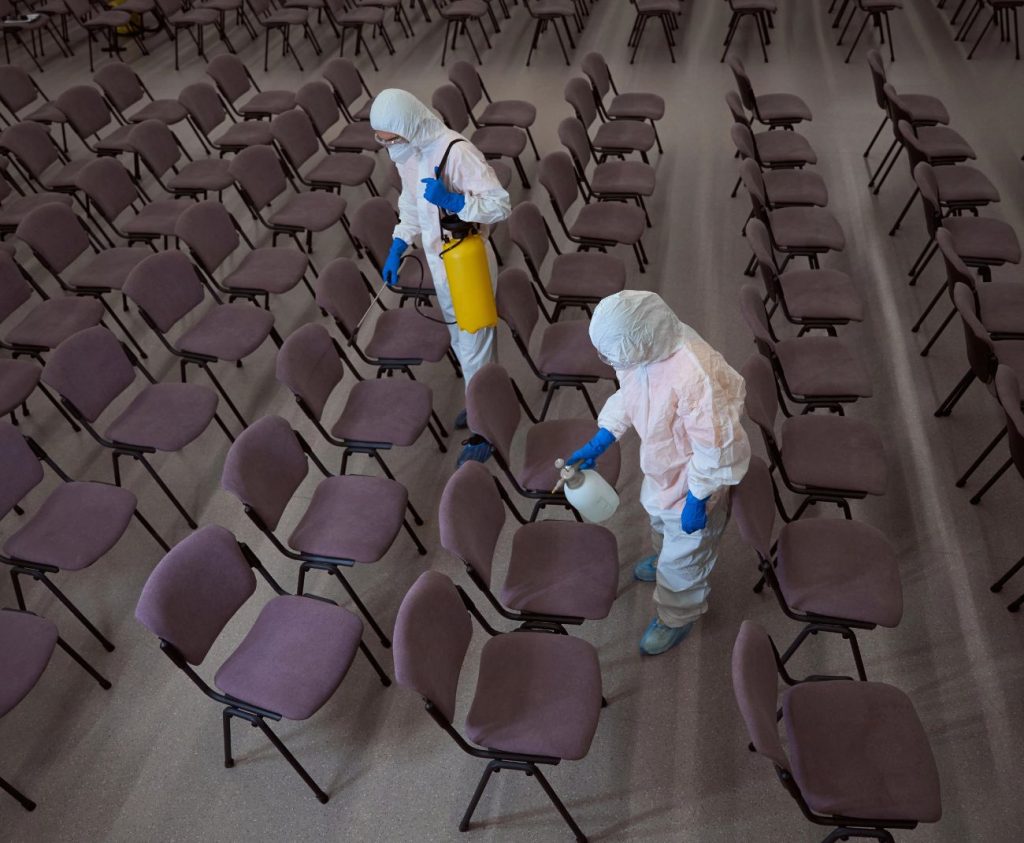 Two specialists performing viral disinfection services for an auditorium in Cudahy, CA